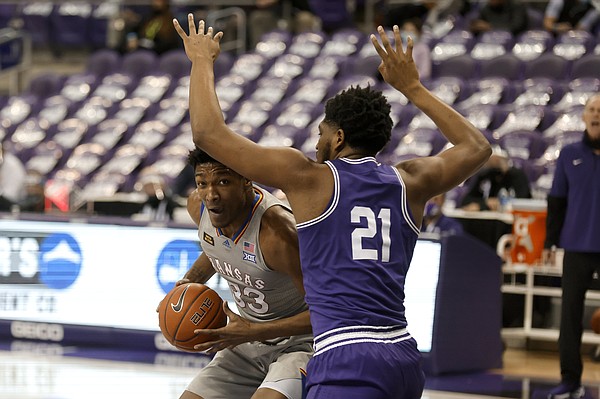 Kansas forward David McCormack (33) works to the basket against TCU center Kevin Samuel (21) in the first half of an NCAA college basketball game in Fort Worth, Texas, Tuesday, Jan. 5, 2021. (AP Photo/Ron Jenkins)