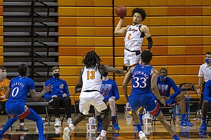 Oklahoma State's Cade Cunningham (2) passes the ball during the second half of the NCAA college basketball game against Kansas in Stillwater, Okla., Tuesday, Jan. 12, 2021. (AP Photo/Mitch Alcala)