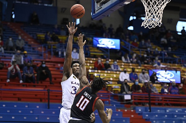 Kansas big man David McCormack shoots over a Texas Tech defender during a game against Texas Tech Saturday afternoon in Allen Fieldhouse on Feb. 20, 2021. Photo by Mike Gunnoe.