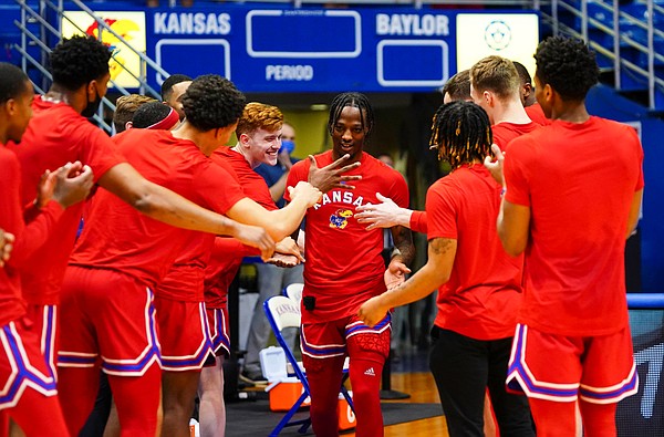 Teammates of Kansas guard Marcus Garrett congratulate him as he is brought out to the court prior to tipoff on Senior Night, Saturday, Feb. 27, 2021 at Allen Fieldhouse.