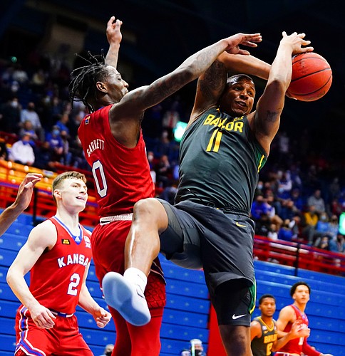 Kansas guard Marcus Garrett (0) pops the ball away from Baylor guard Mark Vital (11) during the second half on Saturday, Feb. 27, 2021 at Allen Fieldhouse.