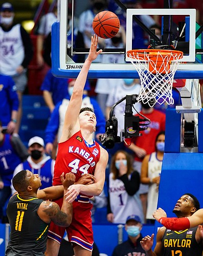 Kansas forward Mitch Lightfoot (44) gets up for a bucket over Baylor guard Mark Vital (11) during the second half on Saturday, Feb. 27, 2021 at Allen Fieldhouse. At right is Baylor guard Jared Butler (12).