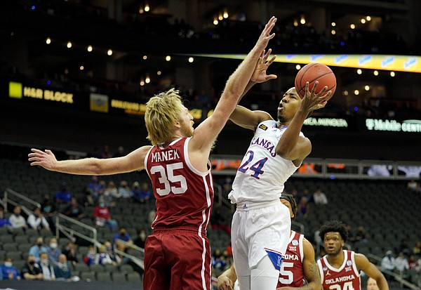 Kansas freshman guard Bryce Thompson goes in for a shot attempt versus Oklahoma's Brady Manek during the Phillips 66 Big 12 Basketball Championship at the T-Mobile Center in Kansas City, Missouri on March 10, 2021.