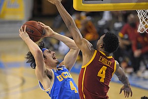 UCLA guard Jaime Jaquez Jr., left, shoots as Southern California forward Evan Mobley defends during the second half of an NCAA college basketball game Saturday, March 6, 2021, in Los Angeles. USC won 64-63. (AP Photo/Mark J. Terrill)