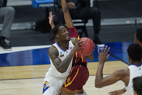Kansas guard Marcus Garrett (0) tries to shoot around a USC defender during the first half of a men's college basketball game in the second round of the NCAA tournament at Hinkle Fieldhouse in Indianapolis, Monday, March 22, 2021. (AP Photo/Paul Sancya)