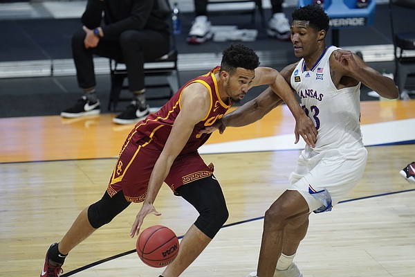 USC forward Isaiah Mobley (3) drives on Kansas forward David McCormack (33) during the second half of a men's college basketball game in the second round of the NCAA tournament at Hinkle Fieldhouse in Indianapolis, Monday, March 22, 2021. (AP Photo/Paul Sancya)