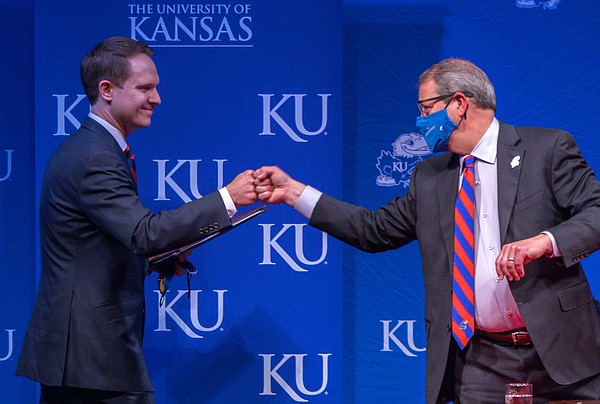 Travis Goff, a 2002 graduate of the University of Kansas and native of Dodge City, left, fist-bumps KU Chancellor Douglas Girod, right, on Wednesday, April 7, 2021, at the Lied Center on KU's west campus.