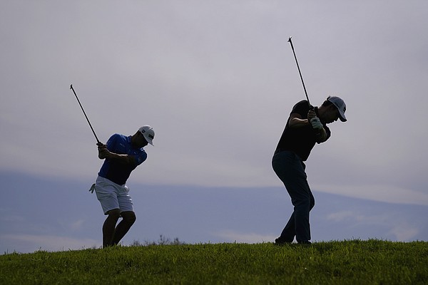 Patrick Cantlay, right, and Gary Woodland chip on the 12th green during a practice round of the U.S. Open Golf Championship, Wednesday, June 16, 2021, at Torrey Pines Golf Course in San Diego.

