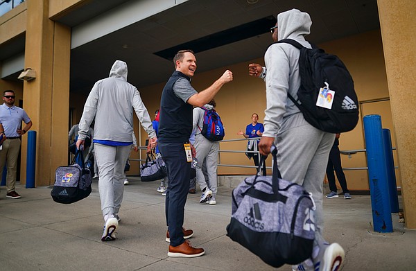 Kansas athletic director Travis Goff greets members of the football team with fist bumps as they head to the locker room prior to kickoff against South Dakota on Friday, Sept. 4, 2021 outside the Anderson Family Football Complex. (Photo by Nick Krug/Special to the Journal-World)
