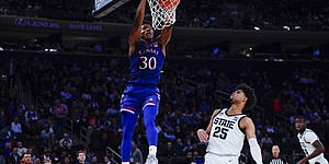 Kansas' Ochai Agbaji (30) dunks the ball in front of Michigan State's Malik Hall (25) during the second half of an NCAA college basketball game Tuesday, Nov. 9, 2021, in New York. Kansas won the game 87-74. (AP Photo/Frank Franklin II)
