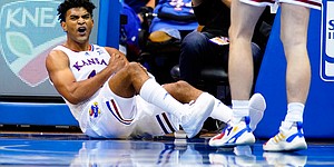 Kansas guard Remy Martin (11) roars after taking a charge during the first half on Friday, Nov. 12, 2021 at Allen Fieldhouse.