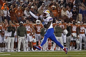 Kansas quarterback Jalon Daniels (6) throws a pass against Texas during the first half of an NCAA college football game in Austin, Texas, Saturday, Nov. 13, 2021. (AP Photo/Chuck Burton)
