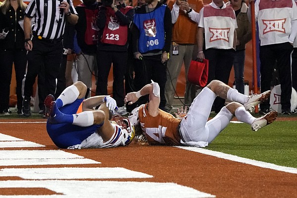 Kansas fullback Jared Casey, left, catches a 2-point conversion past Texas defensive back Brenden Schooler, right, to defeat Texas 57-56 in overtime of an NCAA college football game in Austin, Texas, Saturday, Nov. 13, 2021. (AP Photo/Chuck Burton)