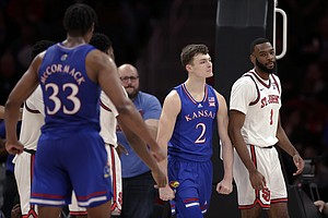 Kansas guard Christian Braun (2) reacts after being fouled by St. John's forward Aaron Wheeler (1) during the second half of an NCAA college basketball game Friday, Dec. 3, 2021, in Elmont, N.Y. Kansas won 95-75. (AP Photo/Adam Hunger)


