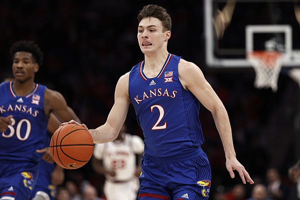 Kansas guard Christian Braun (2) brings the ball up during the first half of the team's NCAA college basketball game against St. John's on Friday, Dec. 3, 2021, in Elmont, N.Y. Kansas won 95-75. (AP Photo/Adam Hunger)