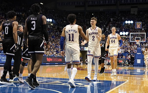 Kansas guard Christian Braun (2) comes to congratulate Kansas guard Remy Martin (11) after Martin got an and-one bucket during the second half on Saturday, Dec. 18, 2021 at Allen Fieldhouse.
