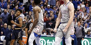 Kansas guard Christian Braun (2) roars after dunking against Nevada during the first half on Wednesday, Dec. 29, 2021 at Allen Fieldhouse.
