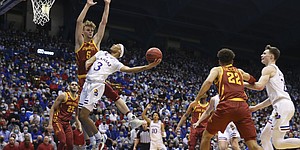 Kansas guard Dajuan Harris Jr. (3) hangs the ball back wide for a bucket against Iowa State Cyclones forward Aljaz Kunc (5) during the first half on Tuesday, Jan. 11, 2022 at Allen Fieldhouse.