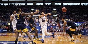 Kansas forward Jalen Wilson (10) throws a pass to the wing against West Virginia during the second half on Saturday, Jan. 15, 2022 at Allen Fieldhouse.