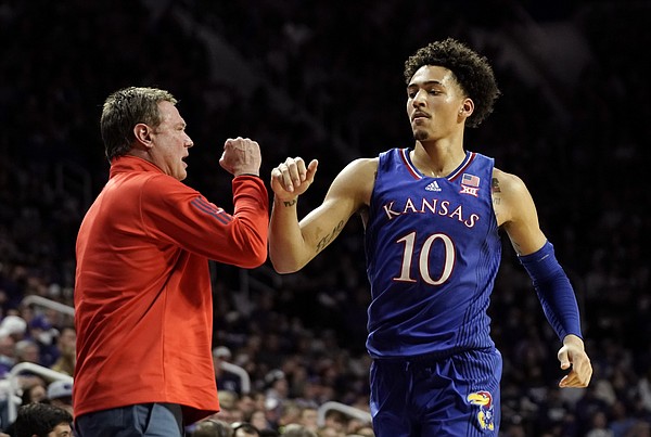 Kansas head coach Bill Self fist bumps Kansas forward Jalen Wilson (10) as he comes out briefly during the second half on Saturday, Jan. 22, 2022 at Bramlage Coliseum.