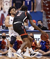 Kansas guard Remy Martin (11) takes a charge from Texas Tech Red Raiders guard Davion Warren (2) during the second half on Monday, Jan. 24, 2022 at Allen Fieldhouse.