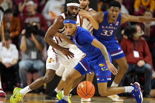 Kansas guard Dajuan Harris Jr. fights for a loose ball with Iowa State guard Tre Jackson, rear, during the first half of an NCAA college basketball game, Tuesday, Feb. 1, 2022, in Ames, Iowa. (AP Photo/Charlie Neibergall)


