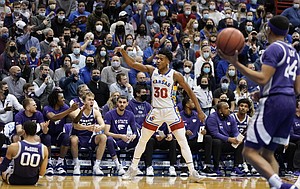 Kansas guard Ochai Agbaji (30) signals a made three and a foul on Kansas State guard Mike McGuirl (00) during the first half on Tuesday, Feb. 22, 2022 at Allen Fieldhouse.
