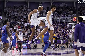 Kansas forward K.J. Adams (24) and Remy Martin (11) walk past as TCU forward Xavier Cork (12) and Micah Peavy (0) celebrate in the second half of an NCAA college basketball game in Fort Worth, Texas, Tuesday, March 1, 2022. (AP Photo/Tony Gutierrez)