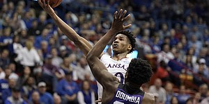 Kansas guard Ochai Agbaji (30) gets in for a bucket against TCU center Souleymane Doumbia (25) during the first half on Tuesday, March 3, 2022 at Allen Fieldhouse.