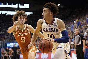 Kansas forward Jalen Wilson (10) drives against Texas guard Devin Askew (5) during the second half on Saturday, March 5, 2022 at Allen Fieldhouse. The Jayhawks defeated the Longhorns, 70-63 to win a share of the Big 12 conference title.