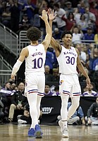 Kansas guard Ochai Agbaji (30) and Kansas forward Jalen Wilson (10) celebrate a dunk by Agbaji during the second half against TCU on Friday, March 11, 2022 at T-Mobile Center in Kansas City.