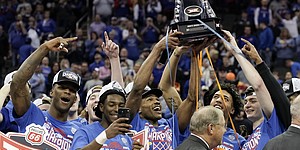 The Kansas Jayhawks hoist the Big 12 Tournament championship trophy following their 74-65 win over Texas Tech on Saturday, March 12, 2022 at T-Mobile Center in Kansas City.