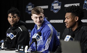 Kansas guard Christian Braun, center, and Kansas guard Remy Martin listen as Kansas guard Ochai Agbaji (30) takes questions during a press conference on Thursday, March 24, 2022 at United Center in Chicago.