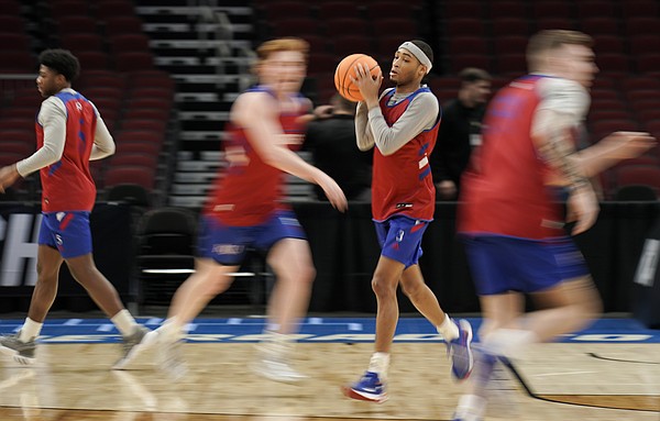 Kansas guard Dajuan Harris Jr. (3) moves through a passing drill during practice on Thursday, March 24, 2022 at United Center in Chicago.
