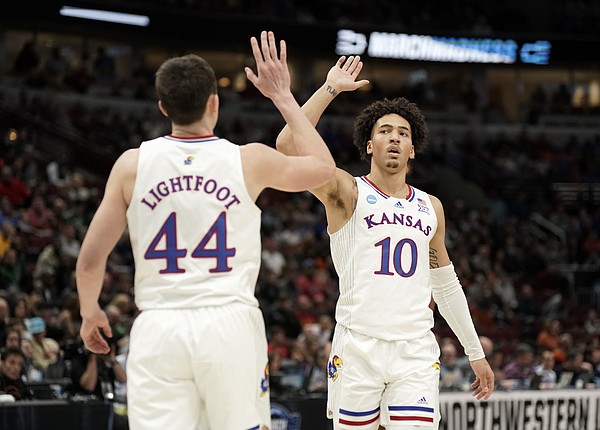 Kansas forward Mitch Lightfoot (44) and Kansas forward Jalen Wilson (10) high five during a Jayhawk run in the first half against Providence on Friday, March 25, 2022 at United Center in Chicago.