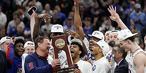 The Kansas Jayhawks celebrate with the Midwest Regional trophy after defeating Miami, 76-50 to advance to the Final Four on Sunday, March 27, 2022 at United Center in Chicago.