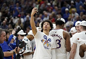 Kansas forward Jalen Wilson (10) shoots a selfie as the Jayhawks celebrate their 76-50 win over Miami to advance to the Final Four.
