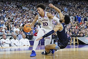 Kansas forward Jalen Wilson drives to the basket past Villanova guard Caleb Daniels during the second half of a Men's Final Four game on April 2, 2022, in New Orleans.