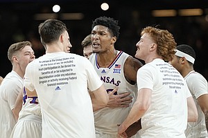 Kansas forward David McCormack, center, celebrates after scoring during the second half of a college basketball game against Villanova in the semifinal round of the Men's Final Four NCAA tournament, Saturday, April 2, 2022, in New Orleans. (AP Photo/David J. Phillip)