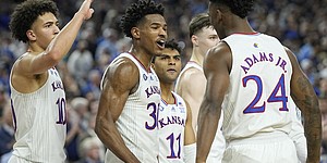 Kansas' Ochai Agbaji (30) celebrates with Jalen Wilson (10), Remy Martin (11) and K.J. Adams (24) after their win against Villanova in a college basketball game in the semifinal round of the Men's Final Four NCAA tournament, Saturday, April 2, 2022, in New Orleans. (AP Photo/David J. Phillip)


