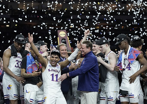 Kansas head coach Bill Self and the Jayhawks celebrate with the NCAA championship trophy.