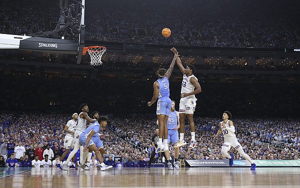 Kansas forward David McCormack (33) turns for a shot over North Carolina forward Armando Bacot (5) during the second half of the NCAA National Championship game on Monday, April 4, 2022 at Caesars Superdome in New Orleans.