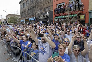 Jayhawk fans line Massachusetts Street to watch a parade and celebrate the KU men’s basketball team’s NCAA basketball championship Sunday, April 10, 2022. 
