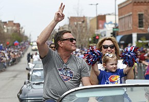 Kansas head coach Bill Self and his wife Cindy and granddaughter Phoebe ride in a parade Sunday, April 10, 2022, to celebrate the KU men’s basketball team winning the NCAA basketball championship.