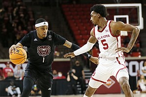 Missouri state guard Isiaih Mosley (1) dribbles alongside Oklahoma guard Marvin Johnson (5) in the first half of a National Invitational Tournament basketball game in Norman, Oklahoma, Tuesday, March 15, 2022 (AP Photo/Nate Billings)