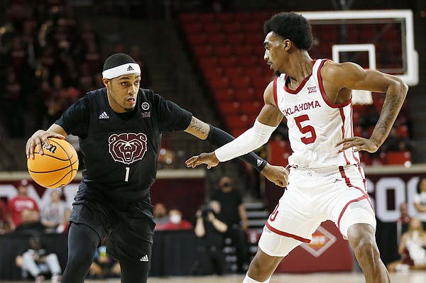 Missouri State guard Isiaih Mosley (1) dribbles next to Oklahoma guard Marvin Johnson (5) in the first half of a National Invitational Tournament college basketball game in Norman, Okla., Tuesday, March 15, 2022. (AP Photo/Nate Billings)