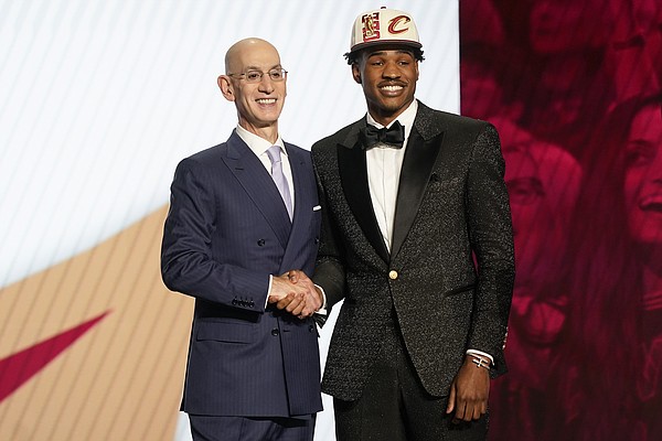 Ochai Agbaji is congratulated by NBA Commissioner Adam Silver =after being selected 14th overall by the Cleveland Cavaliers in the NBA basketball draft, Thursday, June 23, 2022, in New York. (AP Photo/John Minchillo)


