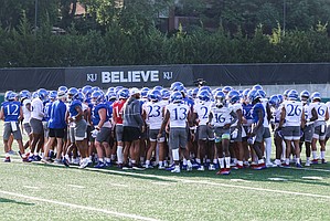 The Kansas football team huddles up during the first day of practice on Tuesday, Aug. 2, 2022.
