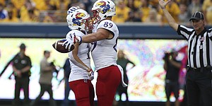 Kansas wide receiver Luke Grimm, left, and tight end Mason Fairchild celebrate after a touchdown is scored against West Virginia during a game in Morgantown, W.Va., on Sept. 10, 2022.