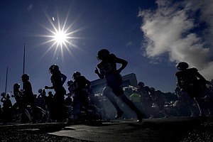 Kansas players run onto the field before an NCAA college football game against Duke Saturday, Sept. 24, 2022, in Lawrence, Kan. (AP Photo/Charlie Riedel)